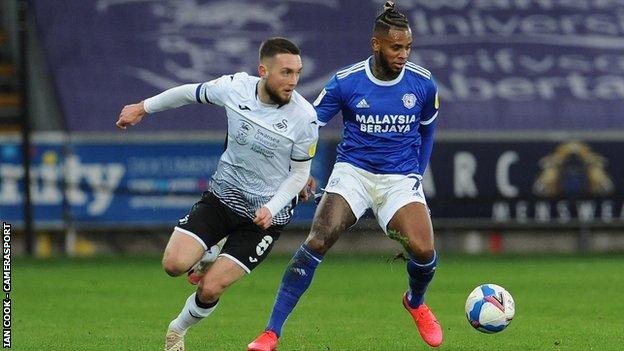 Swansea City's Matt Grimes (L) and Leandro Bacuna of Cardiff City