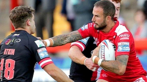 Hull KR's Ben Crooks holds off Salford's Chris Atkin