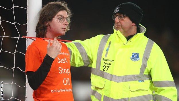 A protestor tied himself to the goalpost during the second half