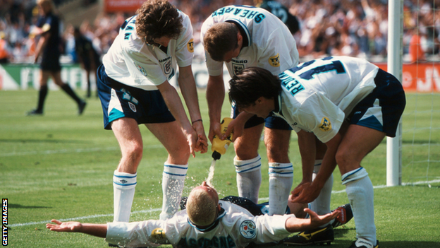 Paul Gascoigne is sprayed by his team-mates after scoring against Scotland