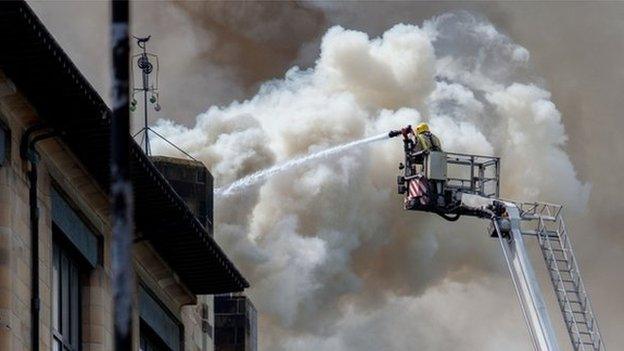 fireman pouring water on Glasgow School of Art