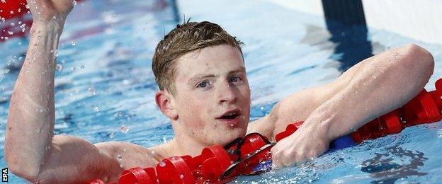 Adam Peaty celebrates in the pool