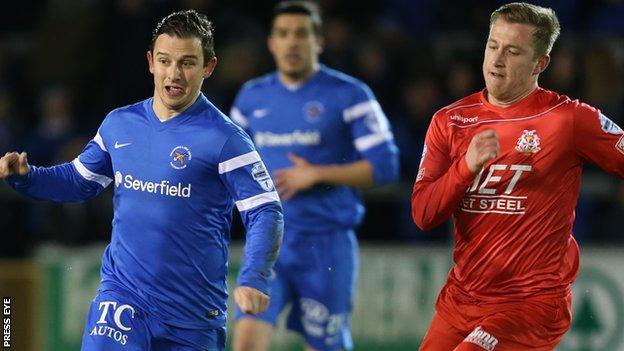 Ballinamallard's Shane McCabe is chased by Portadown's Mark McAllister at Ferney Park