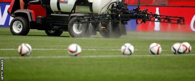 The pitch in Winnipeg is watered before a match