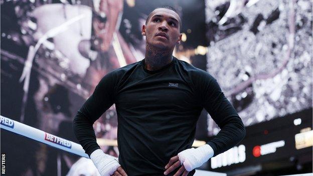 Conor Benn stands with his hands on his hips