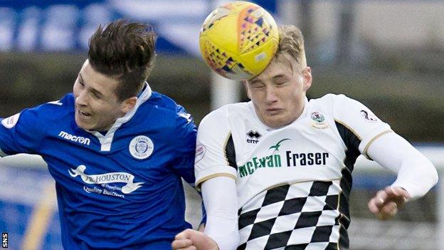 Lyndon Dykes of Queen of the South and Inverness CT's Coll Donaldson contest possession