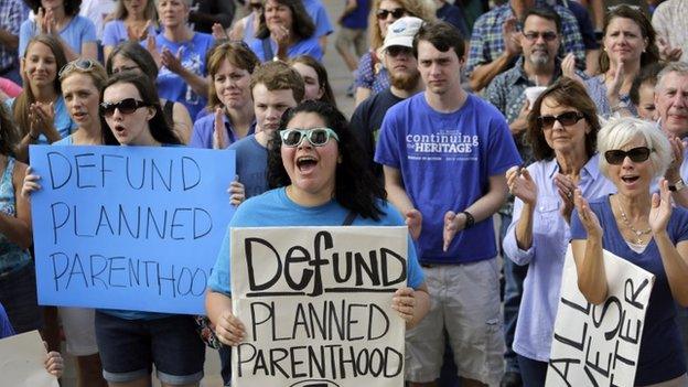 In this July 28, 2015, file photo, Erica Canaut, center, cheers as she and other anti-abortion activists rally on the steps of the Texas Capitol in Austin, Texas,