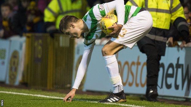 Mikael Lustig picks up an object from the pitch as he prepares to take a throw-in for Celtic at Motherwell