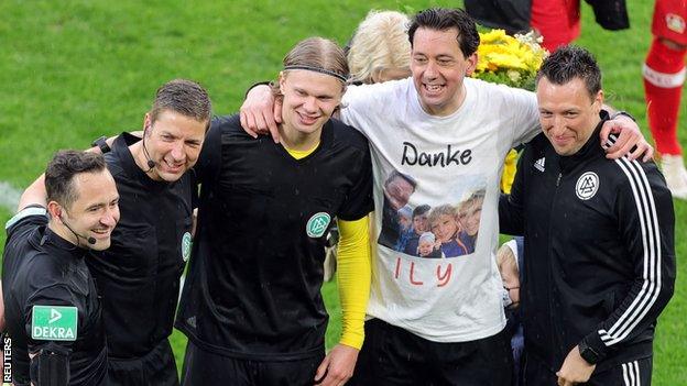 Erling Braut Haaland with the match officials