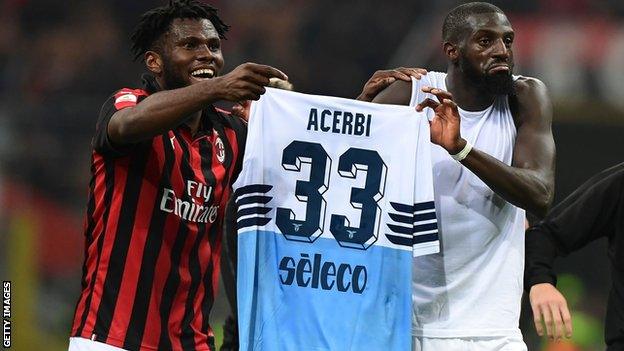 Franck Kessie and Tiemoue Bakayoko holding up Lazio defender Francesco Acerbi's shirt
