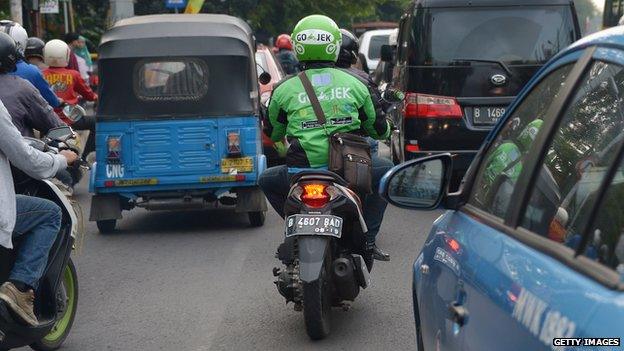 A Go-Jek rider in heavy traffic