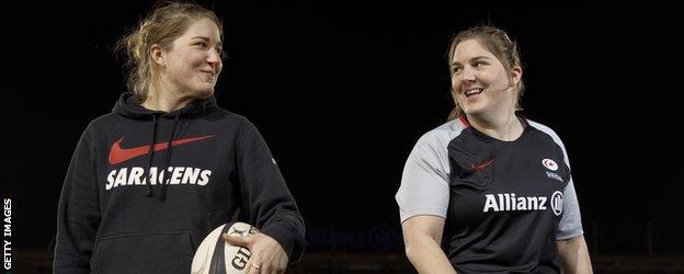 Poppy and Bryony Cleall smile at each other in Saracens kit