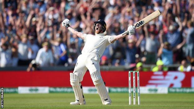 Ben Stokes celebrates with both arms aloft