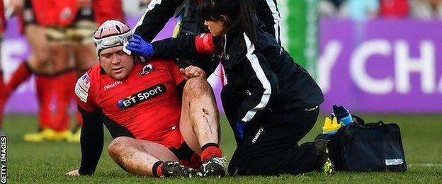 WP Nel receives treatment after suffering an injury playing for Edinburgh against Harlequins