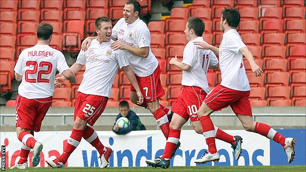 Mark McAllister celebrates with Linfield team-mates after scoring in the Irish Cup final against Crusaders