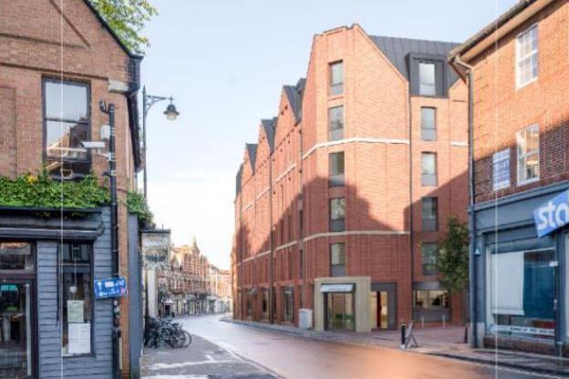 A modern building in place of the cinema. It still has red bricks but the increased number of windows give more of an impression of an apartment-type complex.