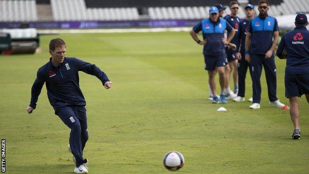 England captain Eoin Morgan kicks a football during practice