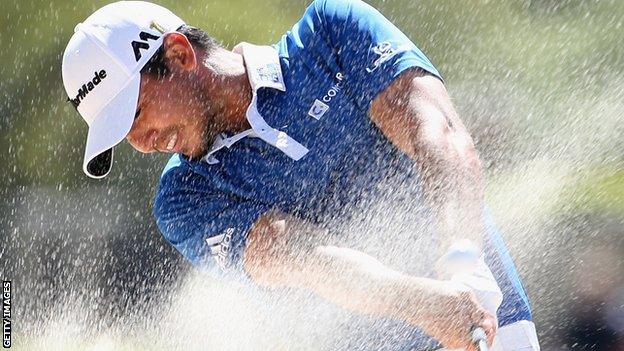 Jason day plays out of a bunker