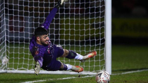 Newport County goalkeeper Tom King saves during a penalty shoot-out in the FA Cup third round game against Brighton and Hove Albion