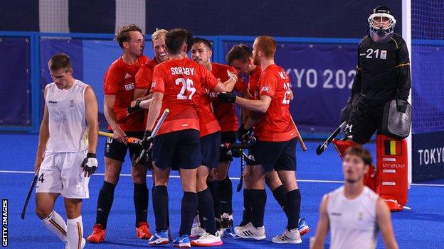 Great Britain players celebrate a goal against Belgium