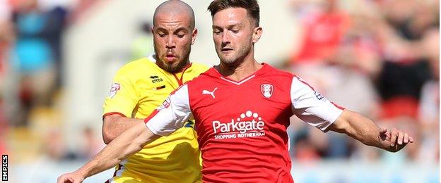 Rotherham's Lee Frecklington is challenged by Sam Carruthers