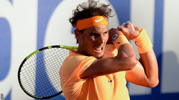 Rafael Nadal plays a backhand