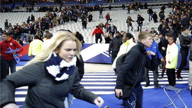 Fans fled onto the Stade de France pitch after the game on 13 November