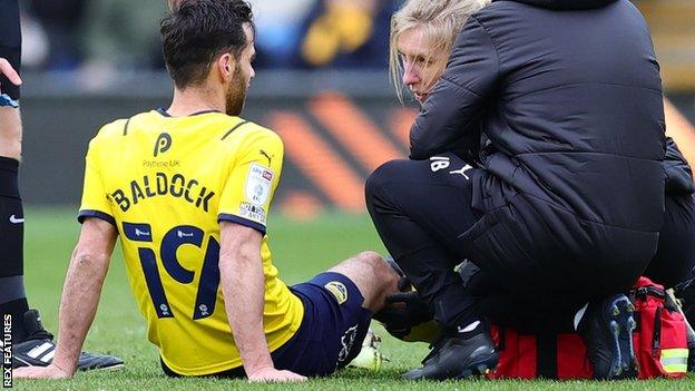 Sam Baldock treated for injury in Oxford United's win against Burton Albion