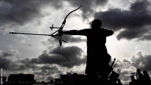 An archer gets ready to fire an arrow