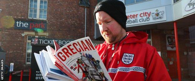 A programme seller at Exeter City