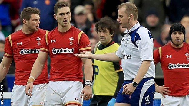 George North (second left) speaks to referee Wayne Barnes during Wales' defeat by France