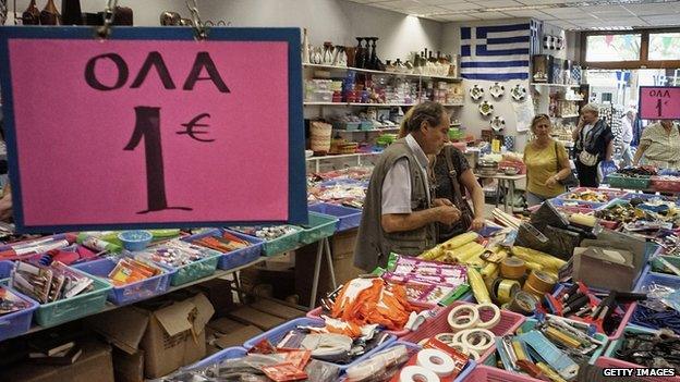 A man buys goods on 23 June 2015 in Athens, Greece.