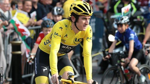 Tour de France winner Geraint Thomas wears the yellow jersey as he cycles through Cardiff at his homecoming parade