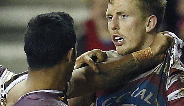 Wigan's Dan Sarginson and Brisbane's Joe Ofahengaue tussle in 2015