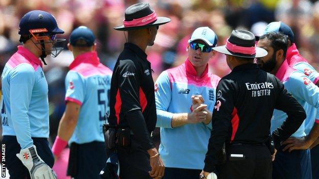 England players gather round the umpires