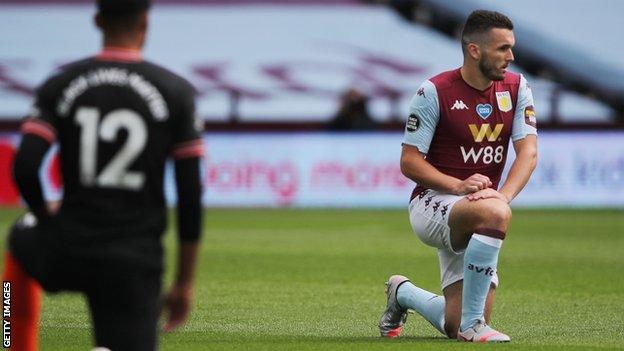 Scotland and Aston Villa midfielder John McGinn taking a knee before kick off in a Premier League match