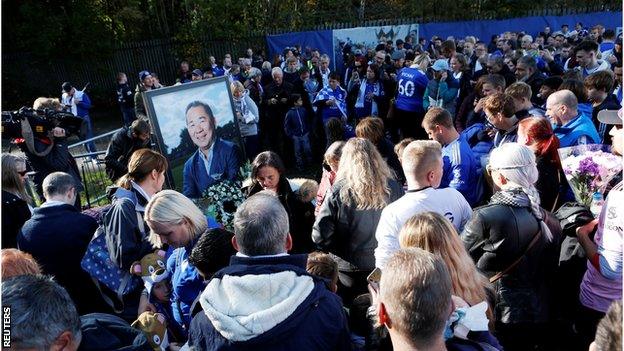 Fans gather at a makeshift shrine