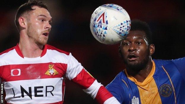 Jon Taylor of Doncaster Rovers (left) and Aaron Pierre of Shrewsbury Town