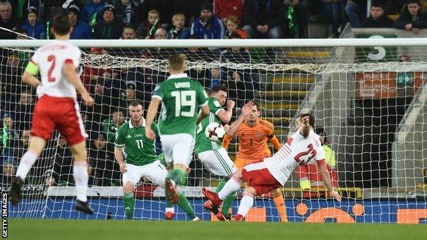 Corry Evans is struck by Xherdan Shaqiri's shot before the referee awarded a penalty