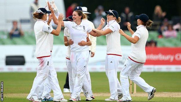 Kate Cross and England team-mates celebrate a wicket against Australia.