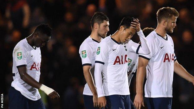 Tottenham players look dejected after defeat by League Two side Colchester United