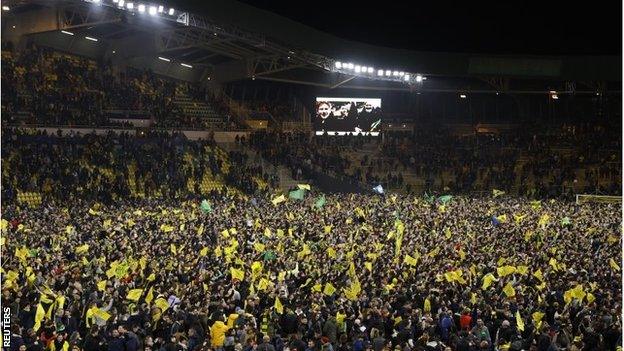 Nantes fans ran onto the pitch to celebrate their penalty shootout win