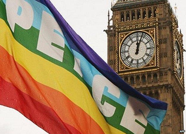 A peace flag is unfurled by Big Ben as the country marks a minute silence for those who died in 7 July attacks
