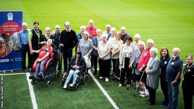 Former Liverpool defender and BBC Sport pundit Mark Lawrenson meets participants of Wigan Athletic's Extra Time Hub