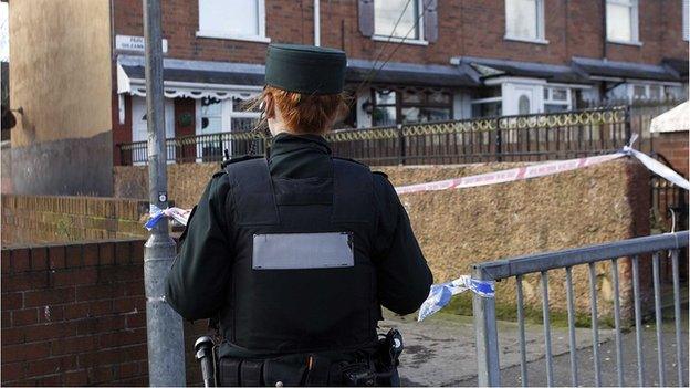 Police remain at the scene of the shooting in north Belfast