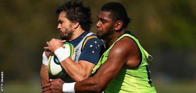 Adam Ashley-Cooper of the Wallabies is tackled by Taqele Naiyaravoro