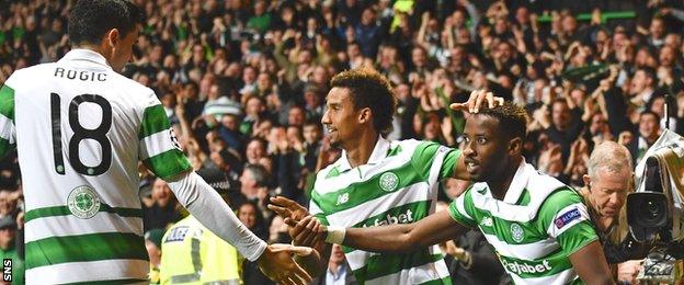 Tom Rogic and Scott Sinclair celebrate with Celtic scorer Moussa Dembele