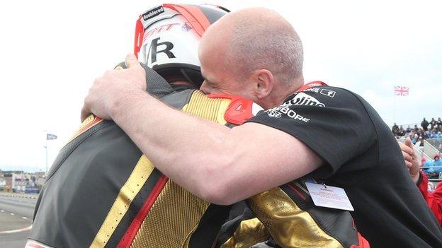 Michael Rutter and team owner Ryan Farquhar embrace after the Supertwins success