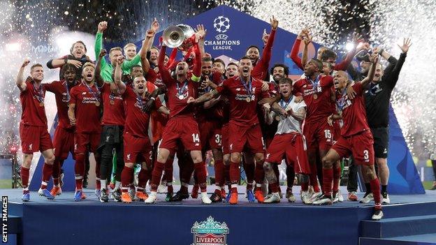 Liverpool players celebrate with the Champions League trophy