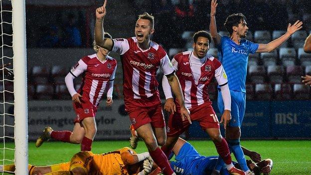 George Ray celebrates scoring for Exeter City against Bradford City in the FA Cup